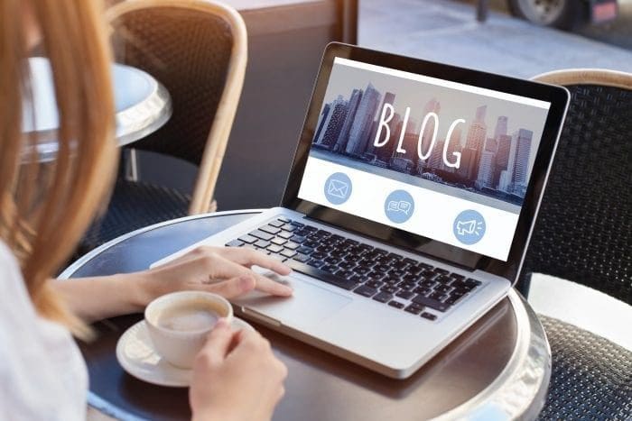 woman looking at blog on laptop
