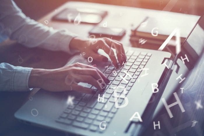 woman typing on laptop